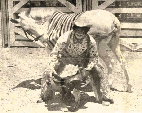 A rodeo clown poses with his trained mule.