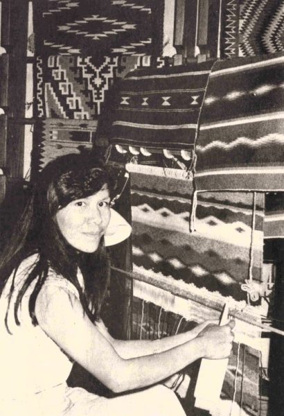 A woman weaves a Navajo textile.