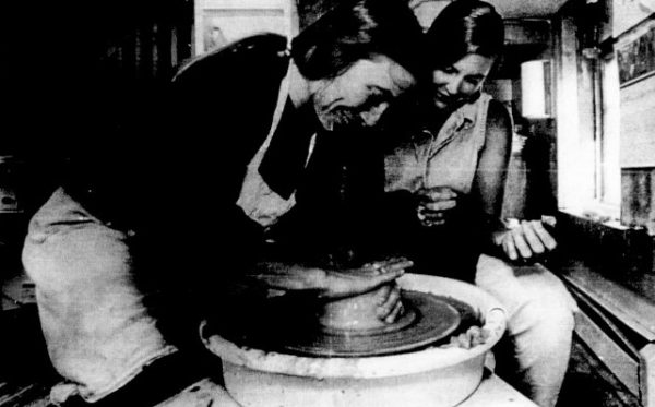 A pottery instructor demonstrates using a pottery wheel