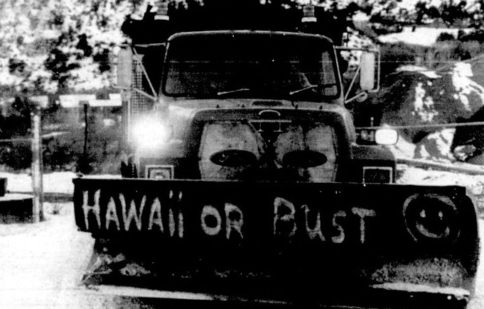 A snowplow displays the ironic text "Hawaii or Bust"