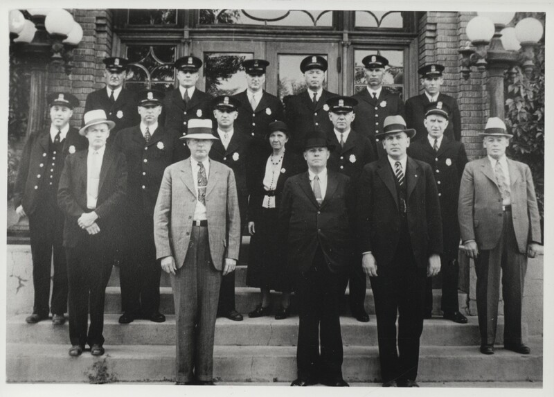 16 men and 1 woman of the Casper Police Force stand on the steps of the police station.